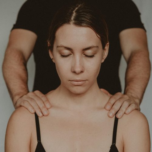 A woman receiving an office massage at her desk