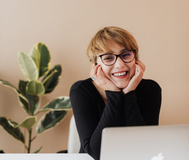 A smiling woman who is relaxed after receiving an office massage